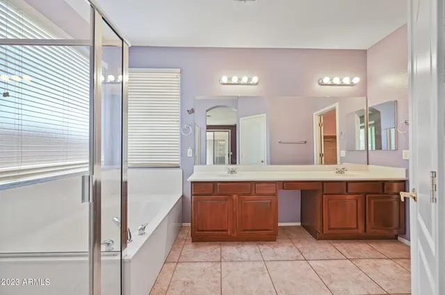 a large bathroom with a large tub and sink