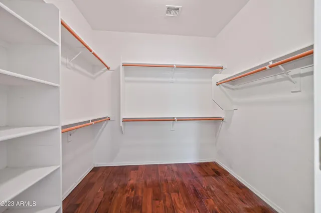 a view of walk in closet with empty racks