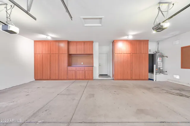 a view of an empty room with closet and a window