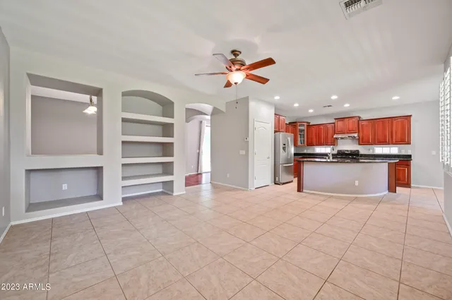 a view of kitchen with cabinets and window