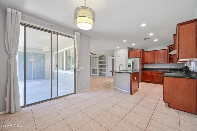 a kitchen with stainless steel appliances granite countertop a refrigerator and a sink