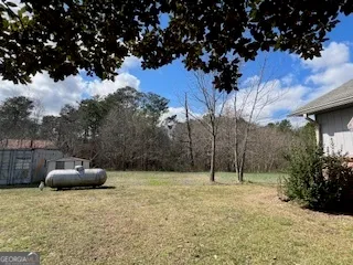 a backyard of a house with lots of green space