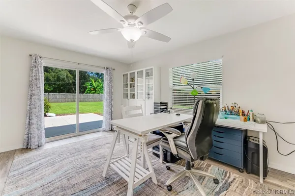 a view of a workspace with furniture and a window