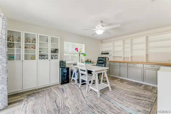 a dining room with furniture and wooden floor