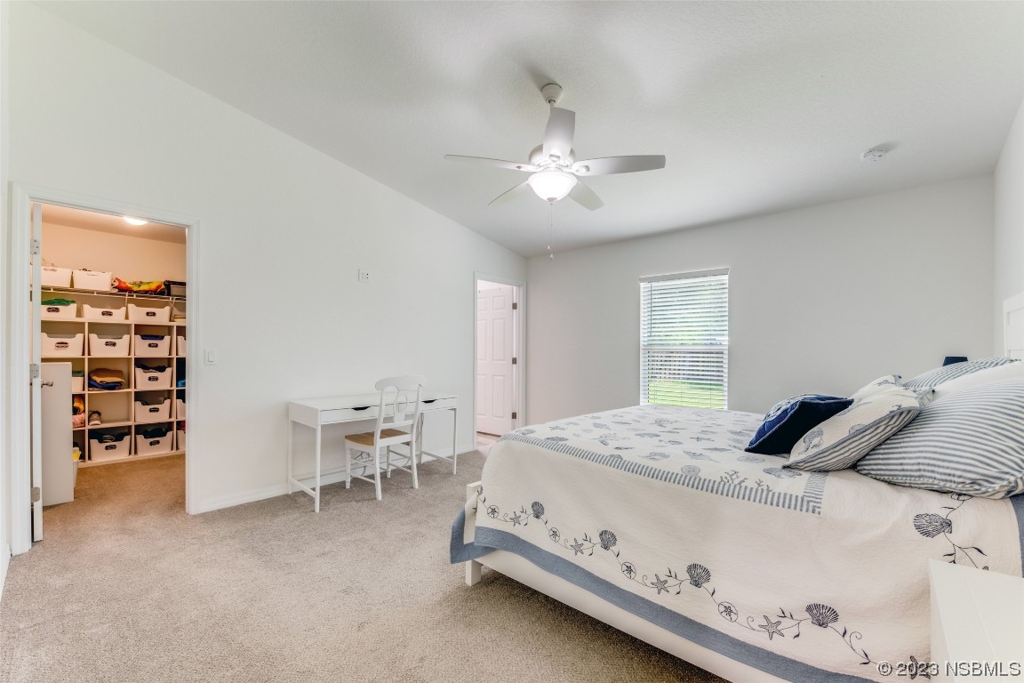 3129 Pine Tree Drive Edgewater, FL 32141 - Photo 13 of 34 a bedroom with a bed and a chair