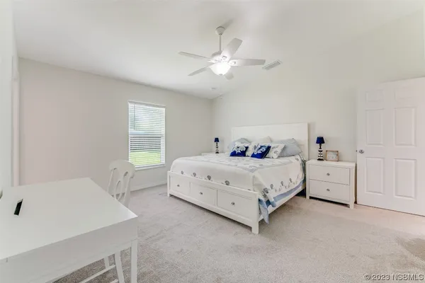 a bed room with a bed and a chandelier