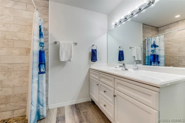 a bathroom with a double vanity sink and mirror