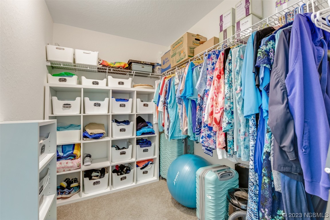 3129 Pine Tree Drive Edgewater, FL 32141 - Photo 19 of 34 a view of walk in closet with clothes and shoes