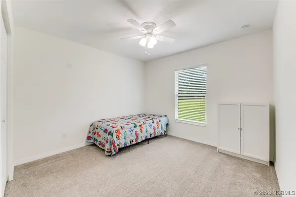 a room with a bed and a chandelier