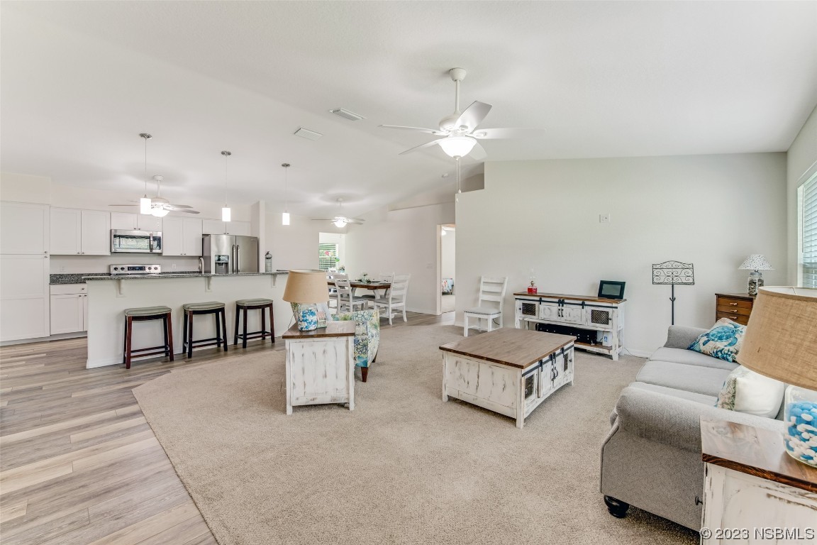3129 Pine Tree Drive Edgewater, FL 32141 - Photo 2 of 34 a living room with furniture and kitchen view