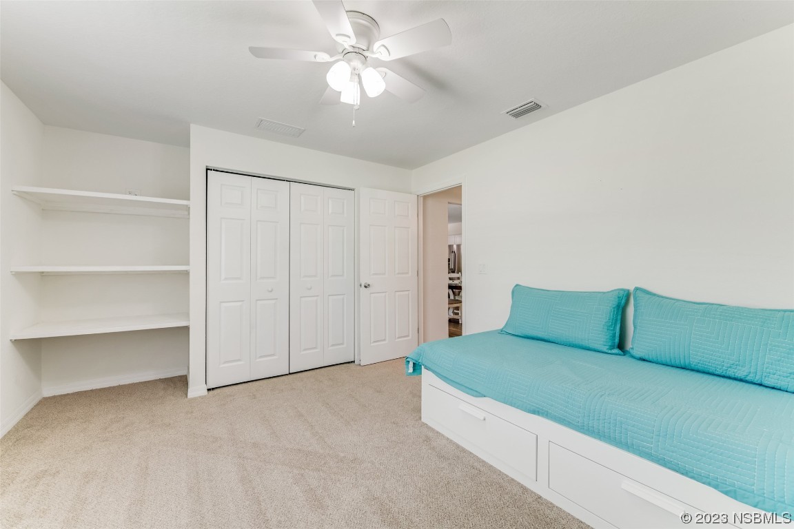 3129 Pine Tree Drive Edgewater, FL 32141 - Photo 22 of 34 a living room with furniture and a chandelier