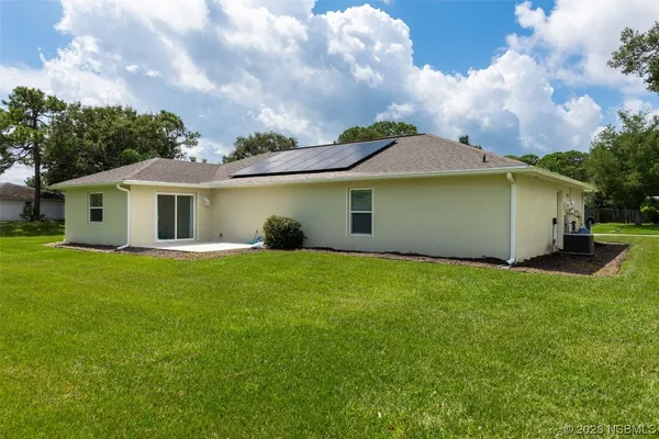a view of a house with a backyard