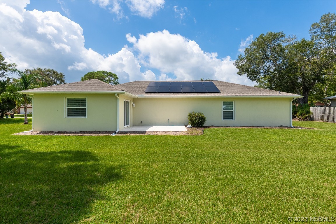 3129 Pine Tree Drive Edgewater, FL 32141 - Photo 29 of 34 a view of a house with a backyard
