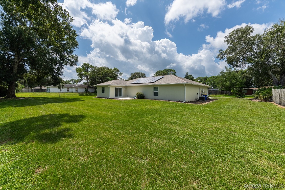 3129 Pine Tree Drive Edgewater, FL 32141 - Photo 32 of 34 a view of a house with a big yard