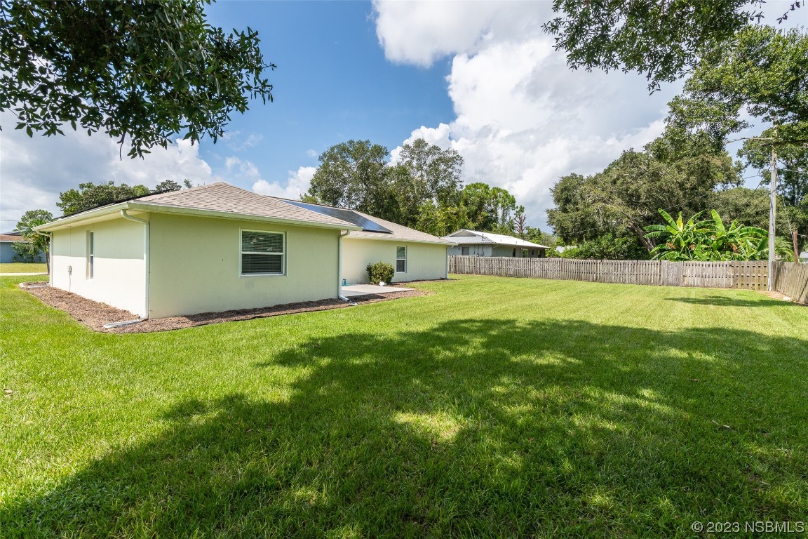 3129 Pine Tree Drive Edgewater, FL 32141 - Photo 33 of 34 a view of a house with a backyard