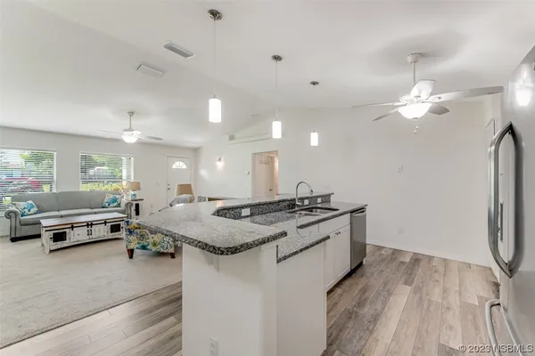 a kitchen with stainless steel appliances granite countertop a stove and a refrigerator