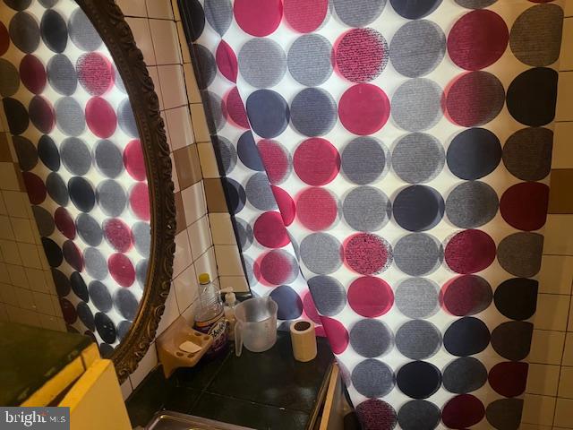 5005 Jackson Street Philadelphia, PA 19124 - Photo 2 of 11 a bathroom with a bathtub and a shower curtain