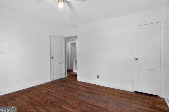 a view of an empty room with wooden floor