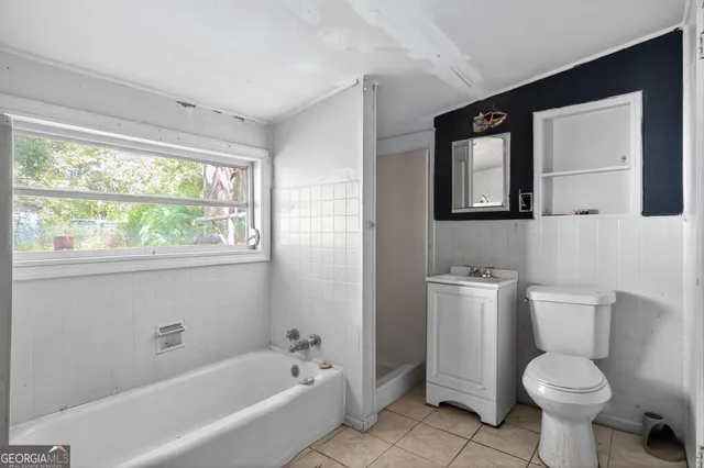 a bathroom with a toilet a sink and bathtub
