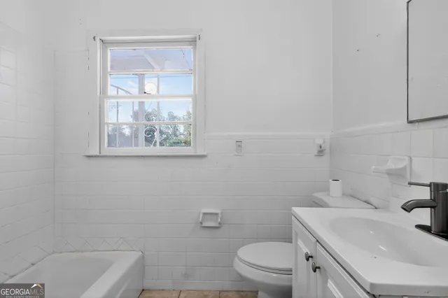 a bathroom with a sink a toilet and a bathtub