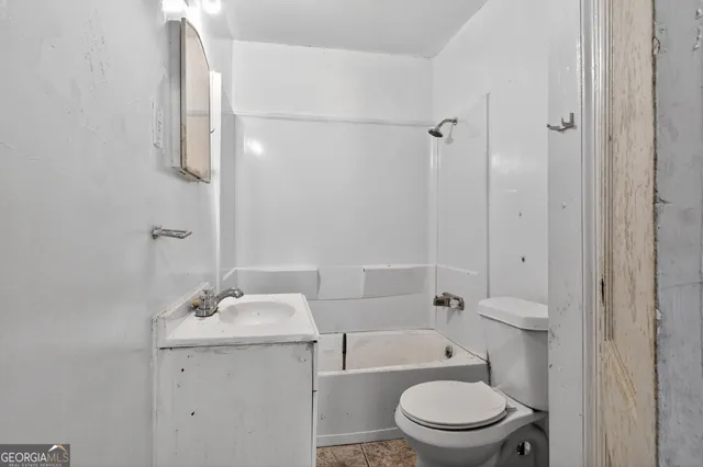 a bathroom with a toilet a sink and shower