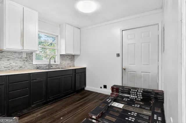 a kitchen with a sink and cabinets