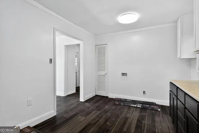 a view of a room with wooden floor and a window