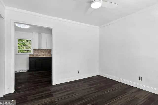 a view of a kitchen with wooden floor and a sink