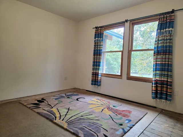 a bed sitting in a bedroom next to a window
