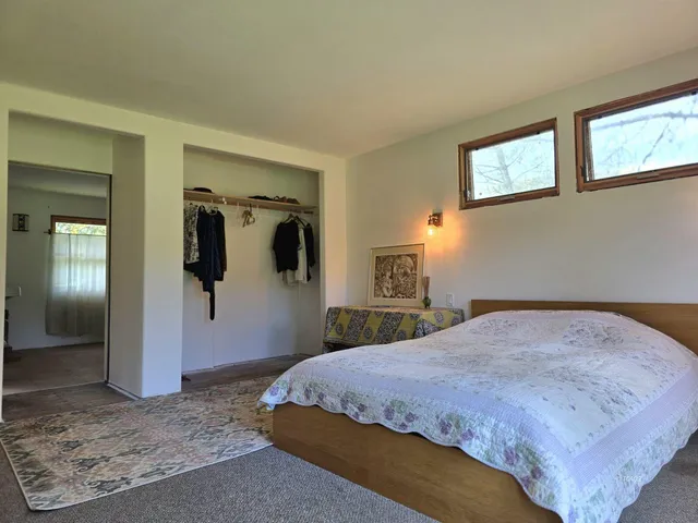 a bedroom with a large bed with wooden floor