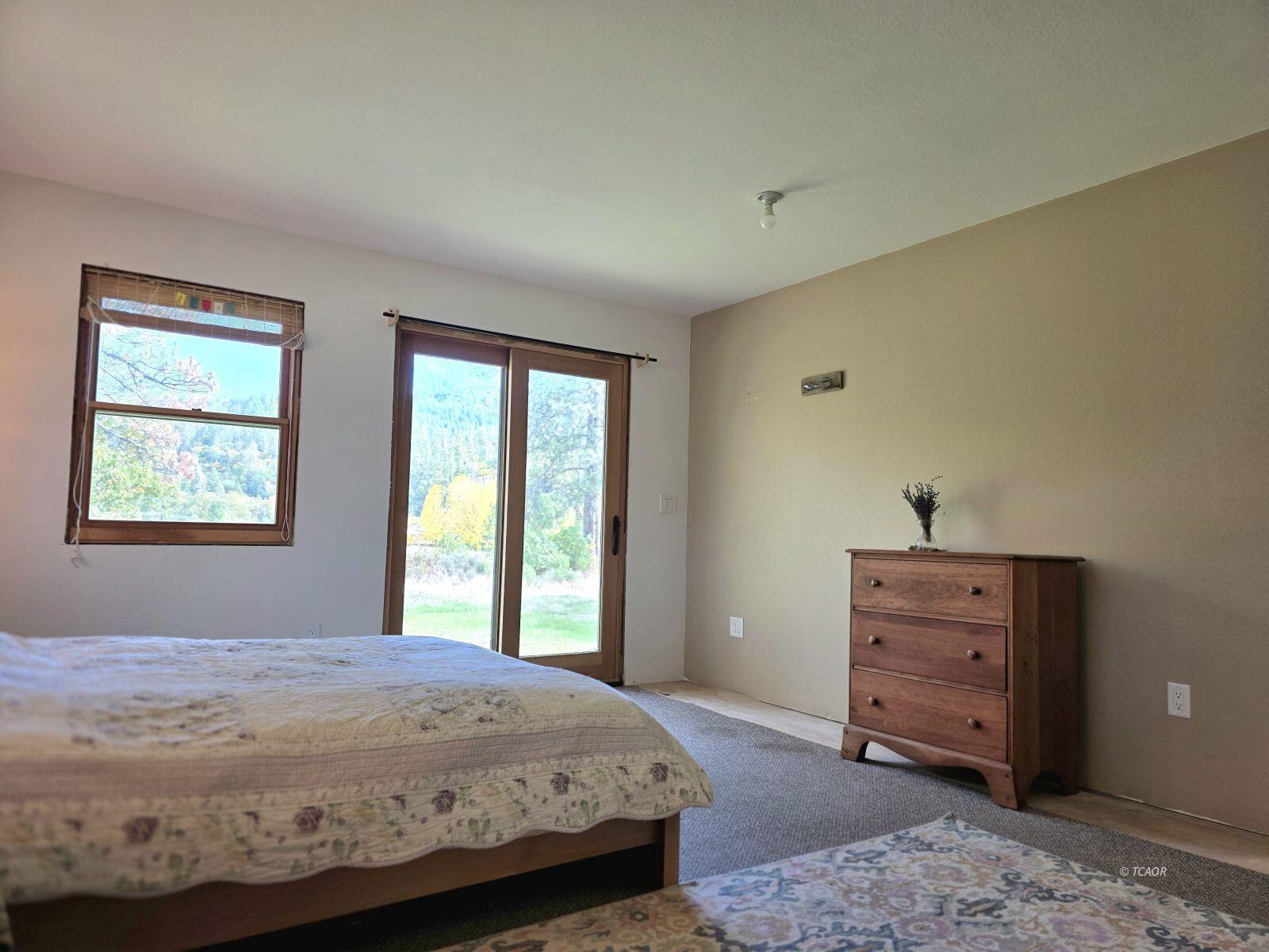 230 Corral Bottom Road Hyampom, CA 96046 - Photo 18 of 42 a bedroom with a bed and a window