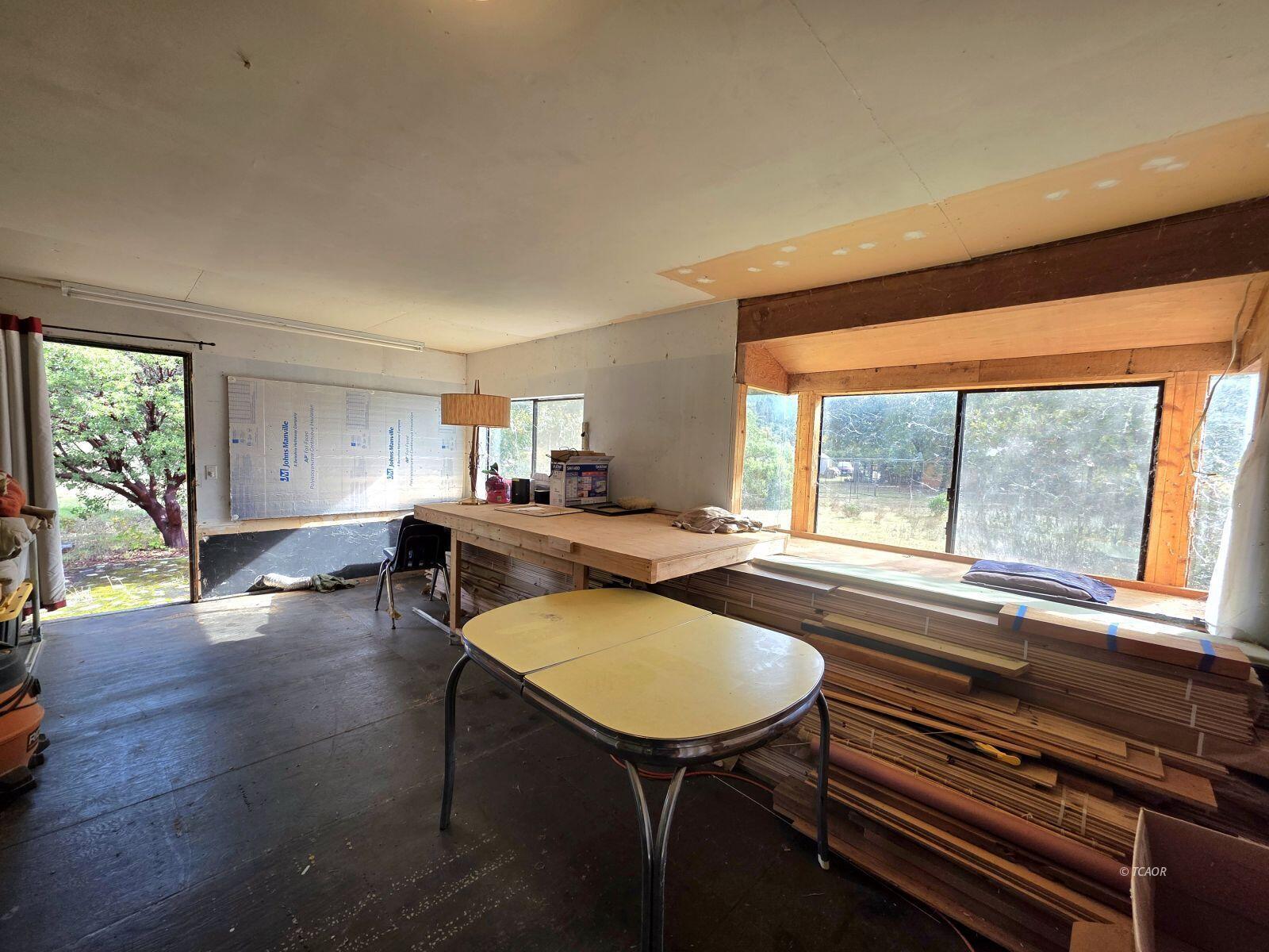 230 Corral Bottom Road Hyampom, CA 96046 - Photo 21 of 42 a living room with furniture stove and a wooden floor