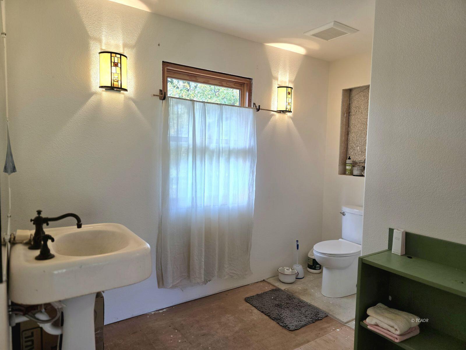 230 Corral Bottom Road Hyampom, CA 96046 - Photo 22 of 42 a bathroom with a sink a toilet and mirror