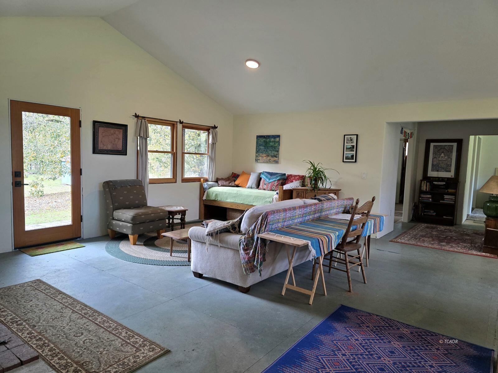 230 Corral Bottom Road Hyampom, CA 96046 - Photo 3 of 42 a living room with furniture a wooden floor and a window