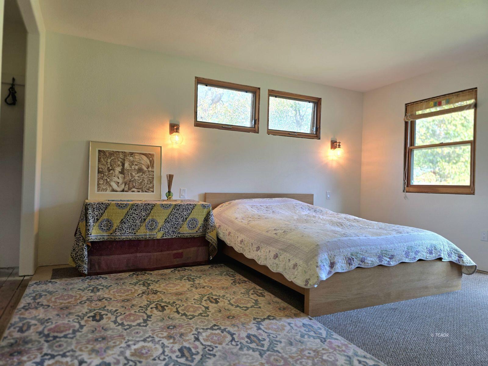 230 Corral Bottom Road Hyampom, CA 96046 - Photo 4 of 42 a bedroom with a bed and painting on the wall