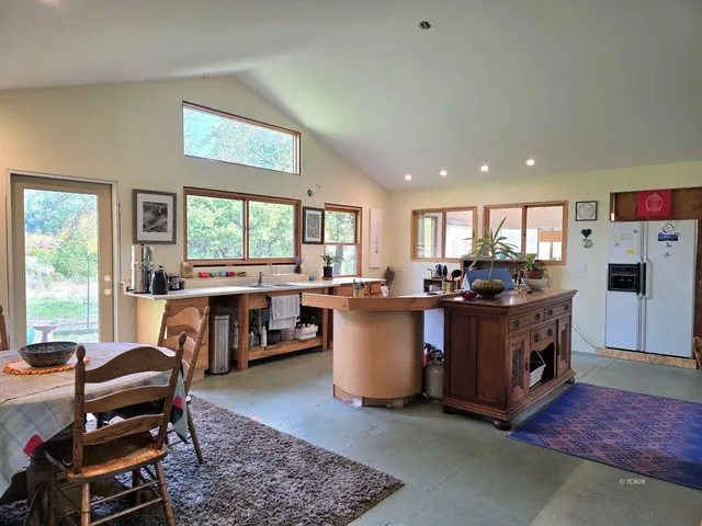 a living room with furniture a window and kitchen view