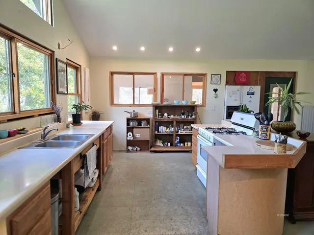 a kitchen with stainless steel appliances a sink stove and cabinets