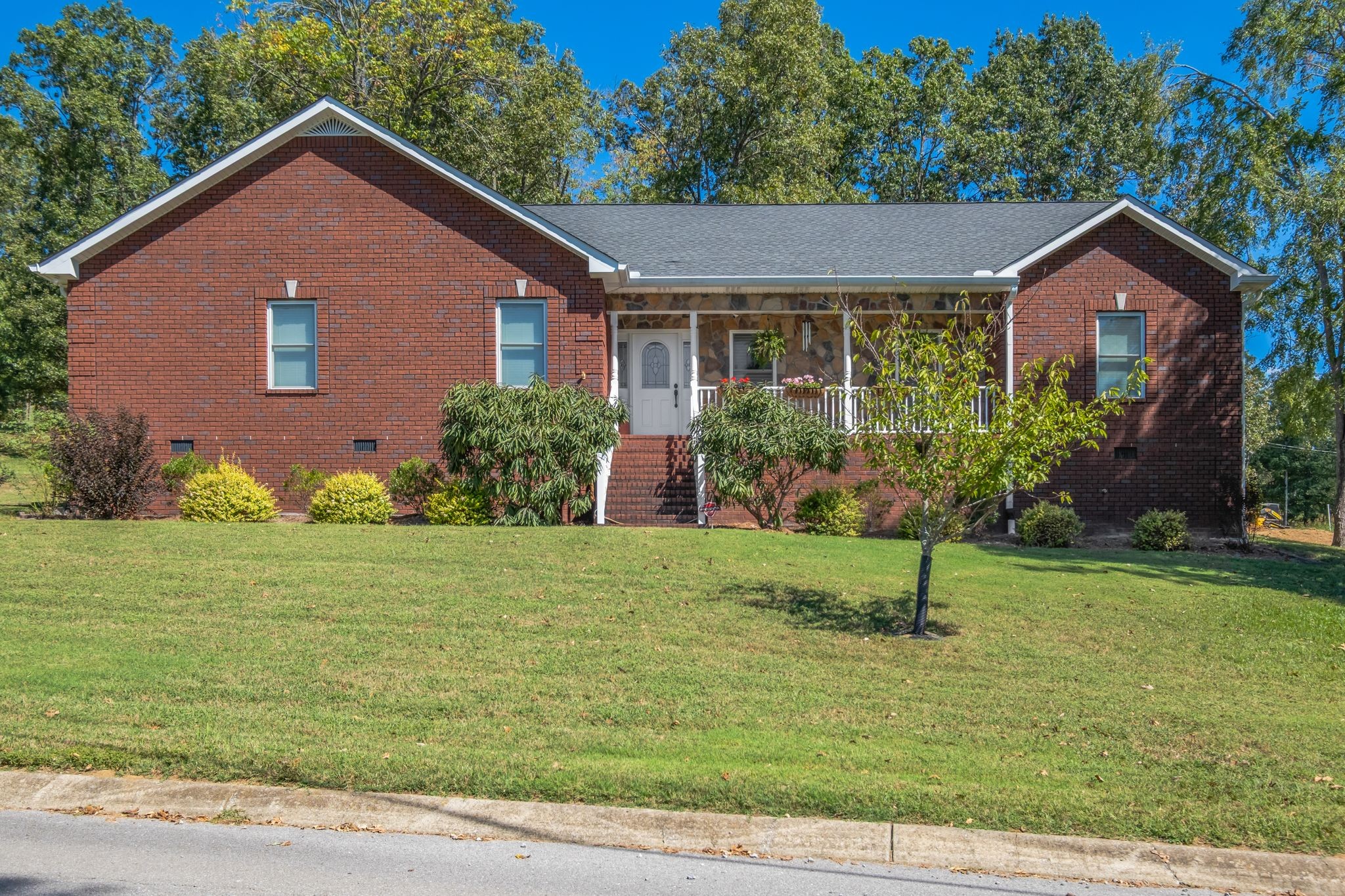 a front view of a house with garden