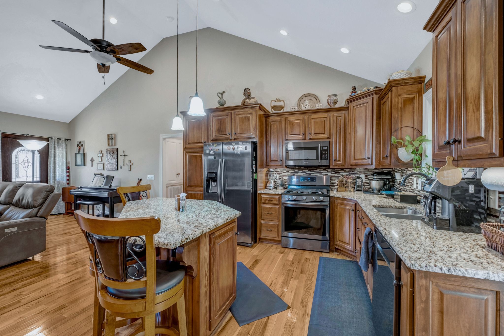 200 Hickory Ridge Lane Hartsville, TN 37074 - Photo 12 of 35 a kitchen with stainless steel appliances granite countertop a stove refrigerator a sink dishwasher a dining table and chairs with wooden floor