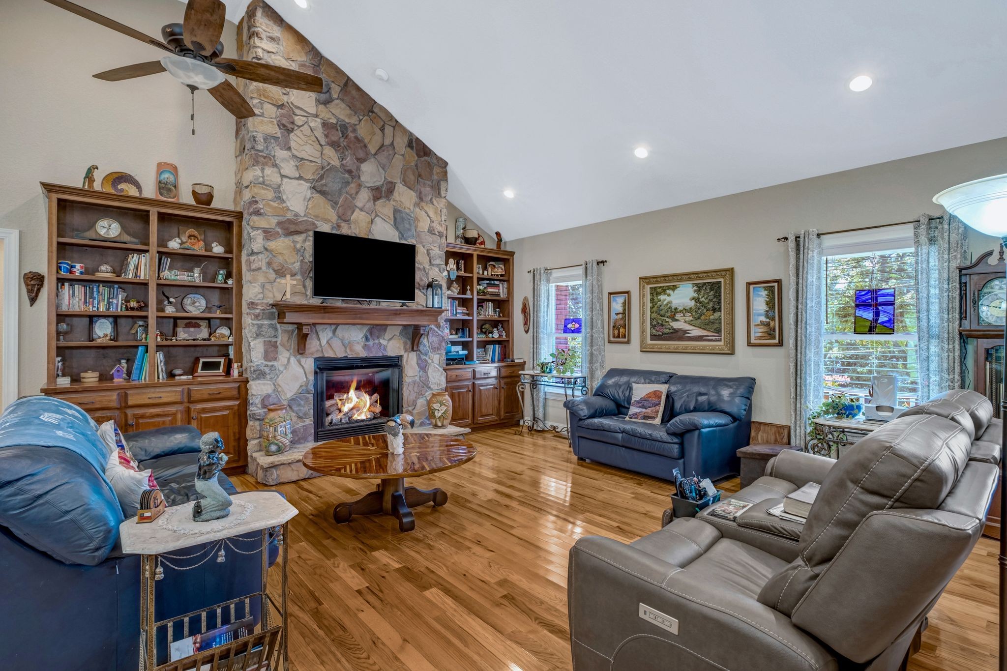 200 Hickory Ridge Lane Hartsville, TN 37074 - Photo 8 of 35 a living room with furniture a flat screen tv and a fireplace