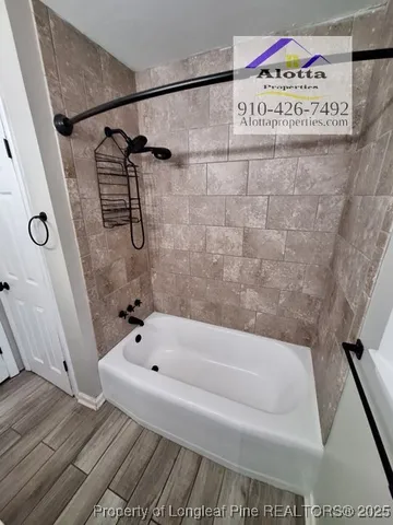 a bathroom with a bathtub and shower