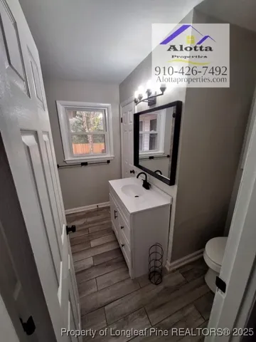 a view of bathroom with a window and mirror