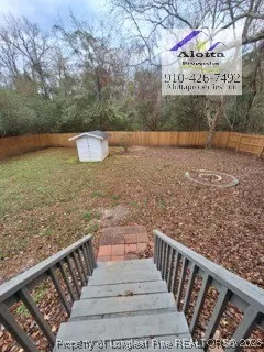 a view of a pathway with a wrought fence
