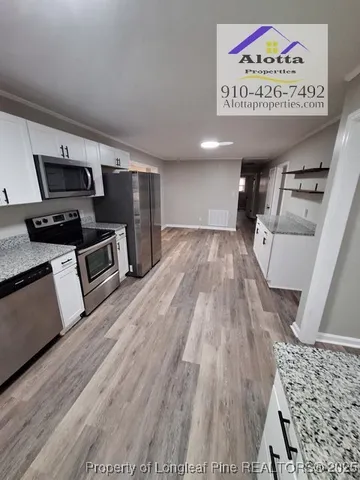 a view of kitchen with microwave and stove