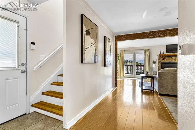 a view of a living room with furniture and wooden floor