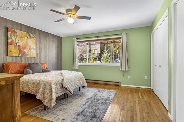 a bedroom with 2 bed and a window