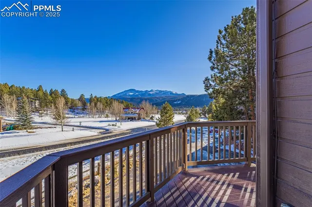 a view of a balcony with a yard