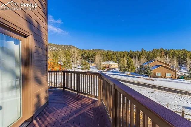 a view of a house with backyard and wooden fence
