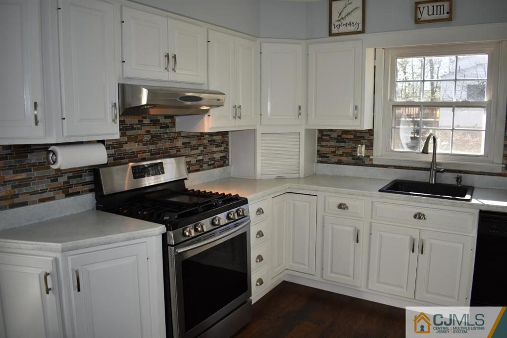 14 Timber Road East Brunswick, NJ 08816 - Photo 8 of 10 a kitchen with granite countertop white cabinets and appliances