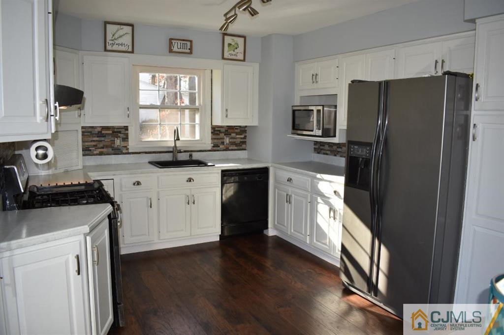 14 Timber Road East Brunswick, NJ 08816 - Photo 9 of 10 a kitchen with a stove a sink and a refrigerator